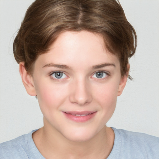 Joyful white young-adult female with short  brown hair and blue eyes