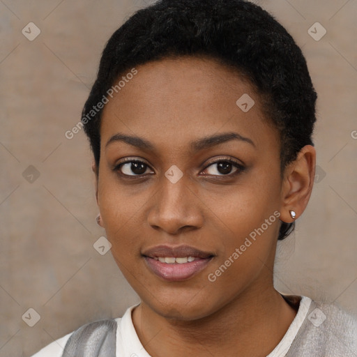 Joyful black young-adult female with short  black hair and brown eyes