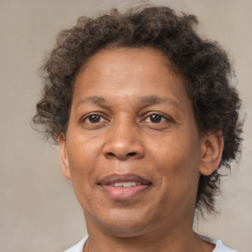 Joyful black adult female with short  brown hair and brown eyes