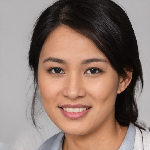 Joyful asian young-adult female with medium  brown hair and brown eyes