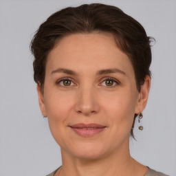 Joyful white adult female with short  brown hair and brown eyes