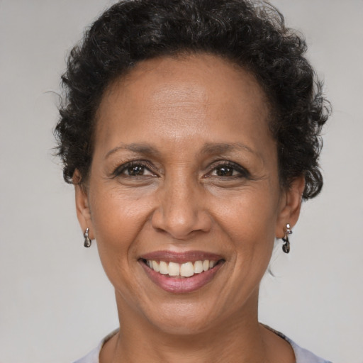 Joyful latino adult female with short  brown hair and brown eyes