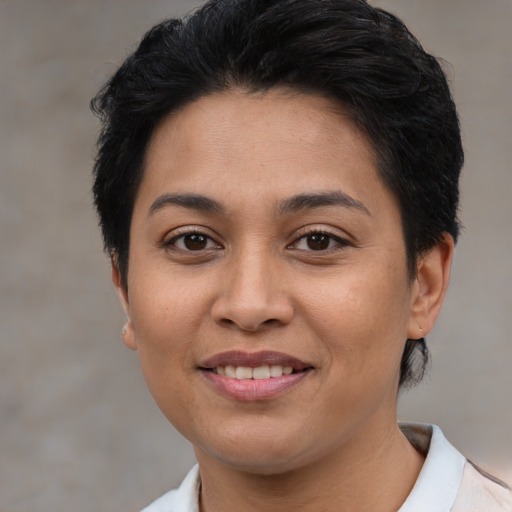 Joyful latino young-adult female with short  brown hair and brown eyes