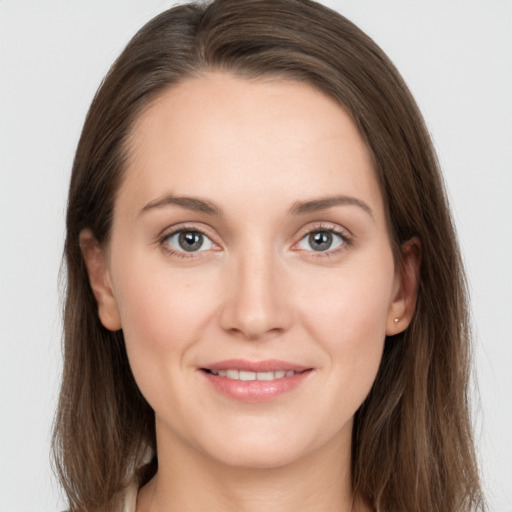 Joyful white young-adult female with long  brown hair and grey eyes