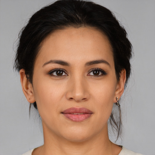 Joyful latino young-adult female with medium  black hair and brown eyes