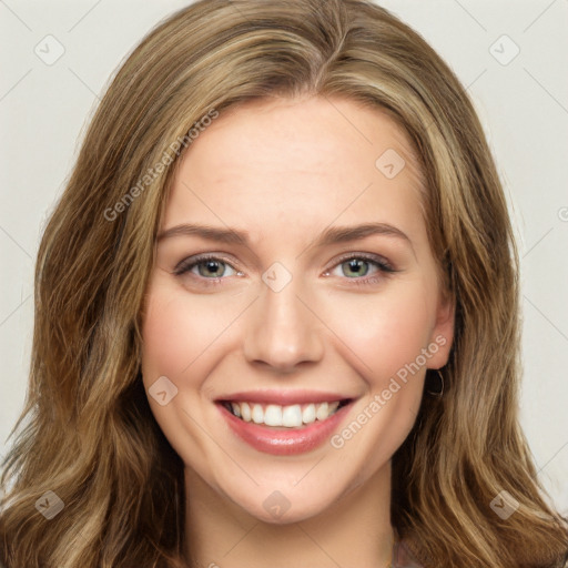 Joyful white young-adult female with long  brown hair and green eyes