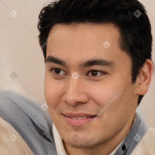 Joyful latino young-adult male with short  brown hair and brown eyes