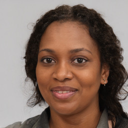 Joyful black young-adult female with medium  brown hair and brown eyes