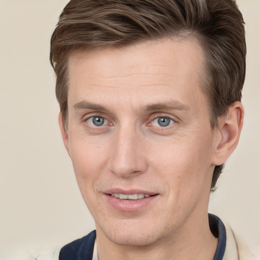 Joyful white adult male with short  brown hair and grey eyes