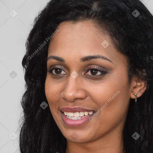 Joyful black young-adult female with long  black hair and brown eyes