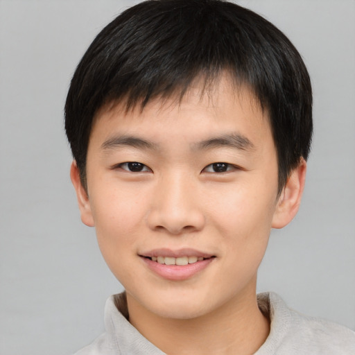 Joyful asian child male with short  brown hair and brown eyes