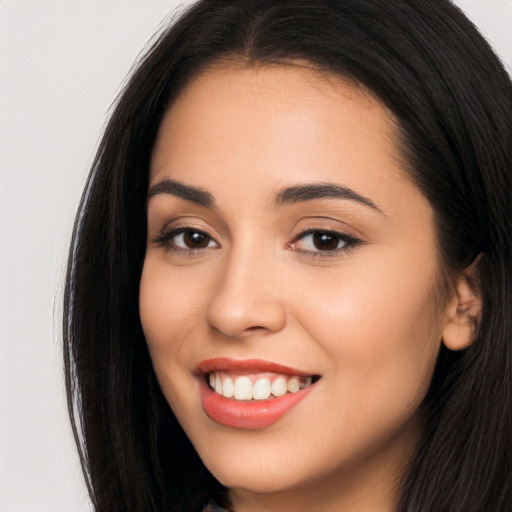 Joyful latino young-adult female with long  brown hair and brown eyes