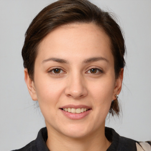 Joyful white young-adult female with medium  brown hair and brown eyes