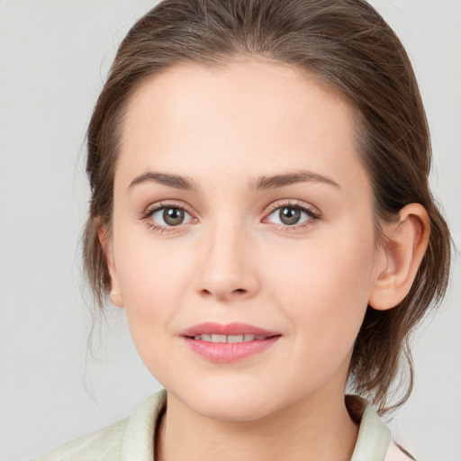 Joyful white young-adult female with medium  brown hair and green eyes