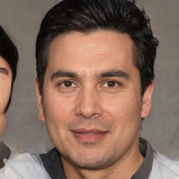 Joyful white adult male with short  black hair and brown eyes