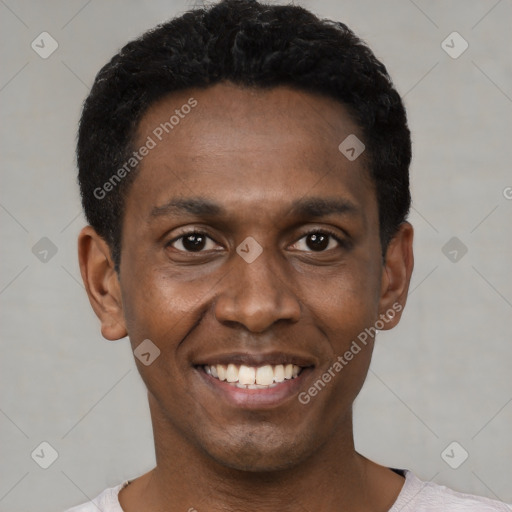 Joyful black young-adult male with short  black hair and brown eyes