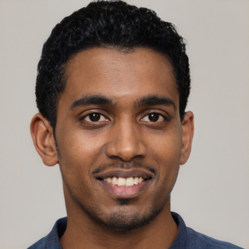 Joyful black young-adult male with short  black hair and brown eyes
