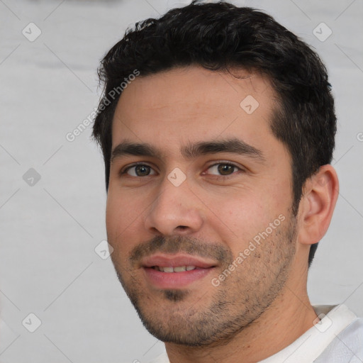 Joyful white young-adult male with short  black hair and brown eyes