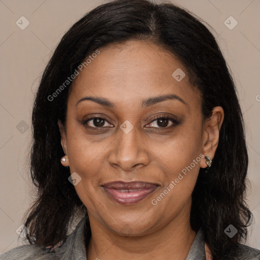 Joyful latino adult female with medium  brown hair and brown eyes