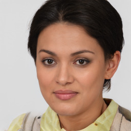 Joyful latino young-adult female with medium  brown hair and brown eyes