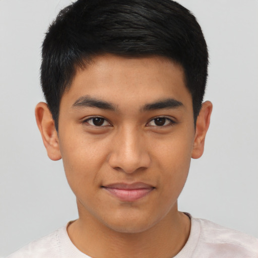 Joyful latino young-adult male with short  black hair and brown eyes