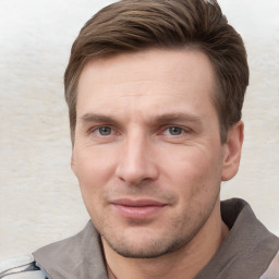 Joyful white young-adult male with short  brown hair and grey eyes