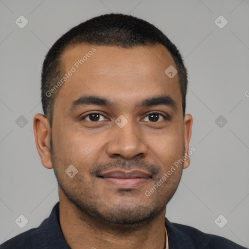 Joyful black young-adult male with short  black hair and brown eyes