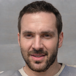 Joyful white adult male with short  brown hair and brown eyes