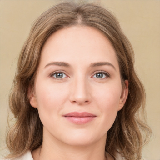 Joyful white young-adult female with medium  brown hair and green eyes