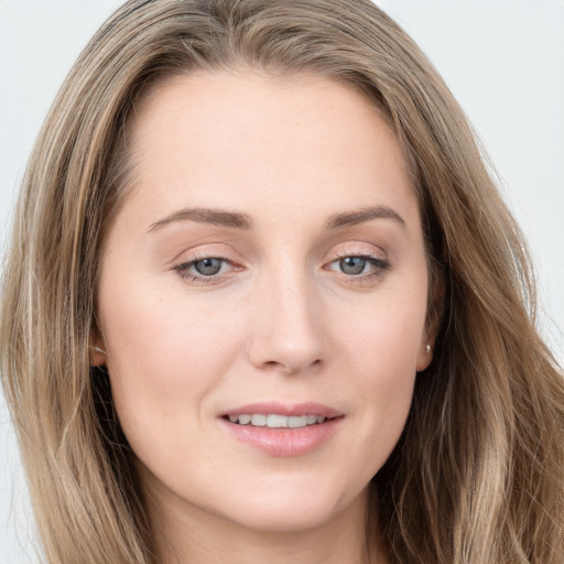 Joyful white young-adult female with long  brown hair and grey eyes