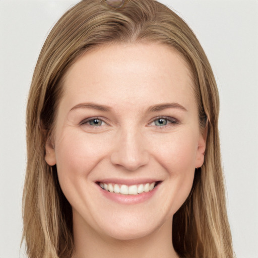 Joyful white young-adult female with long  brown hair and grey eyes