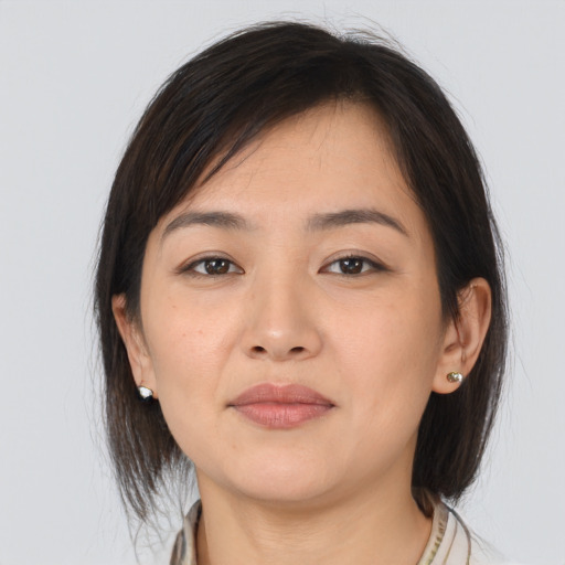 Joyful asian young-adult female with medium  brown hair and brown eyes