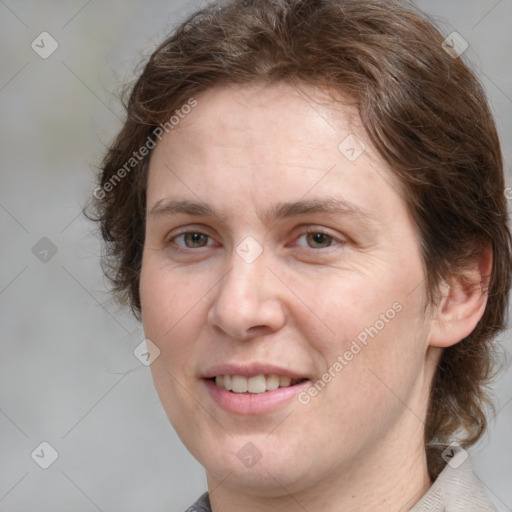 Joyful white adult female with medium  brown hair and grey eyes