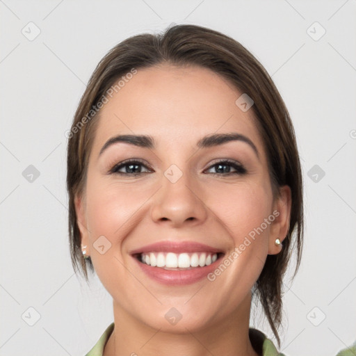 Joyful white young-adult female with medium  brown hair and grey eyes