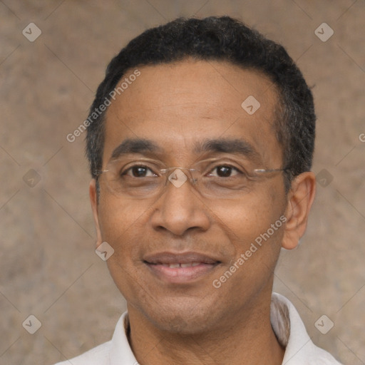 Joyful latino adult male with short  black hair and brown eyes