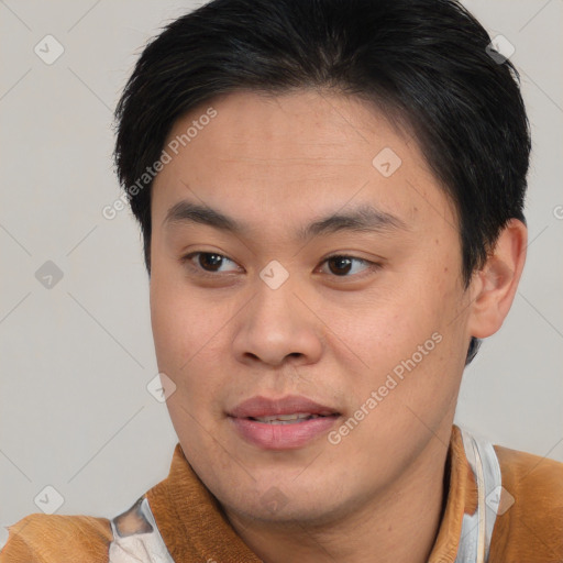 Joyful asian young-adult male with short  brown hair and brown eyes