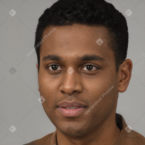 Joyful black young-adult male with short  brown hair and brown eyes