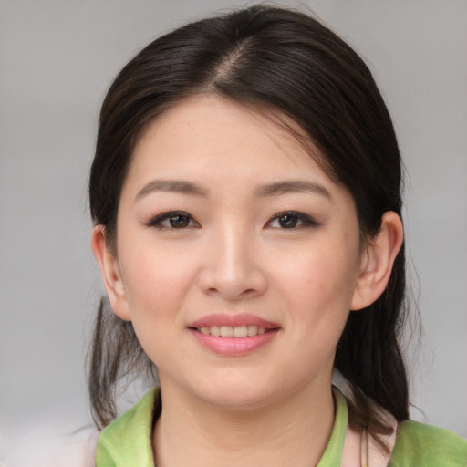 Joyful asian young-adult female with medium  brown hair and brown eyes