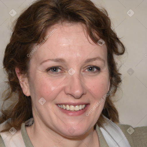 Joyful white adult female with medium  brown hair and blue eyes