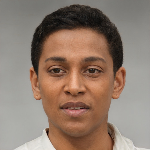 Joyful latino young-adult male with short  brown hair and brown eyes