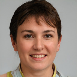 Joyful white young-adult female with short  brown hair and grey eyes