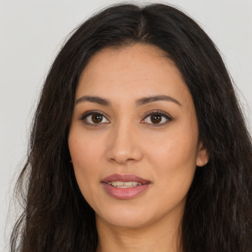 Joyful latino young-adult female with long  brown hair and brown eyes