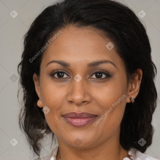 Joyful latino adult female with medium  brown hair and brown eyes