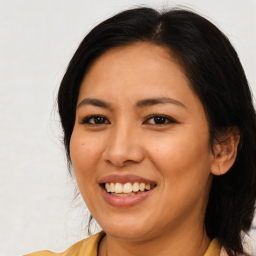 Joyful asian young-adult female with long  brown hair and brown eyes