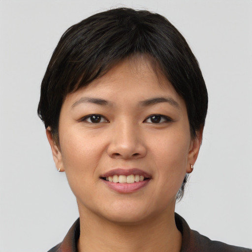 Joyful asian young-adult female with short  black hair and brown eyes