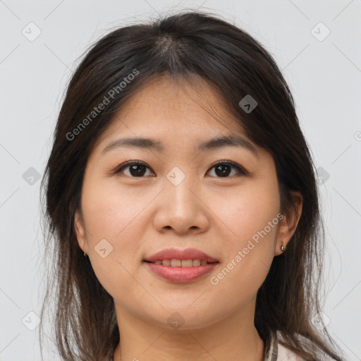 Joyful asian young-adult female with medium  brown hair and brown eyes