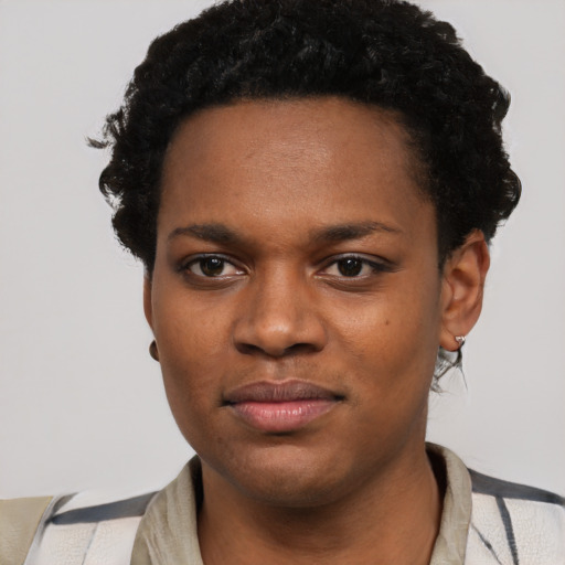 Joyful black young-adult female with short  black hair and brown eyes
