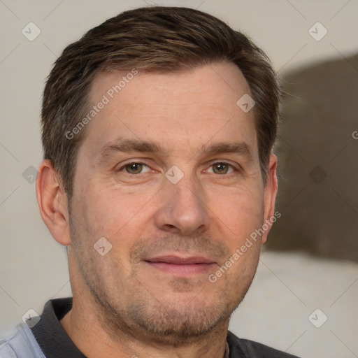 Joyful white adult male with short  brown hair and grey eyes