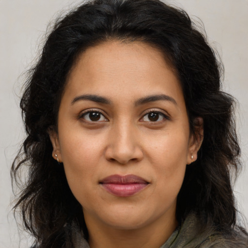 Joyful latino young-adult female with long  brown hair and brown eyes