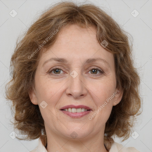 Joyful white adult female with medium  brown hair and grey eyes